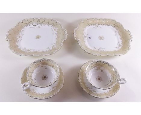 A Victorian cream and gilt tea service comprising: six cups and saucers, and two cake plates 