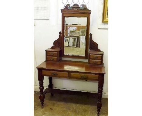 A Victorian mahogany dressing table with trinket drawers and two frieze drawers all raised on turned supports