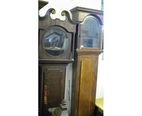 Two longcase clock cases and a large quantity of clock cases, faces and movements etc- the contents of a clock makers worksho