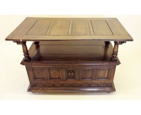 An oak monks bench with carved decoration to back