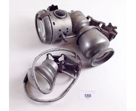 An old acetylene front bicycle headlamp and an electric front bicycle lamp
