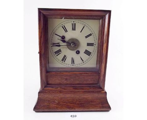 A 1930's oak cased striking mantel clock