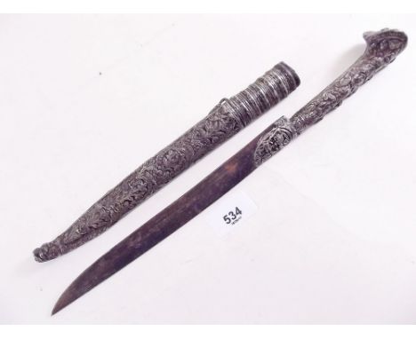 A 19th century Turkish white metal dagger in scabbard with embossed decoration