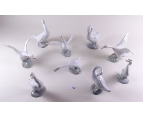 A collection of seven Lladro geese and two Nao ones