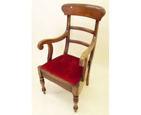 A Victorian mahogany commode chair with scroll over arms 