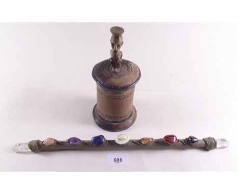 An African tribal pot and cover with figure finial and a clay stick set gem stones 