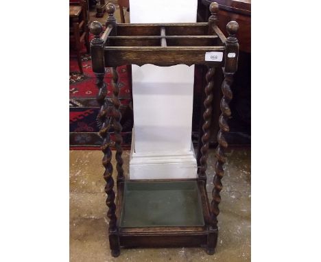 An oak 1920's stick stand with barley twist supports 