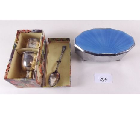 A 1930's chrome and enamel dressing table box and a silver plated egg cup and napkin set 