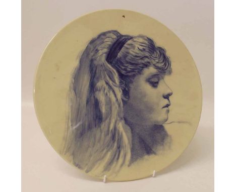 Blue and white circular pottery plaque painted with a portrait of a lady. Condition report: see terms and conditions.