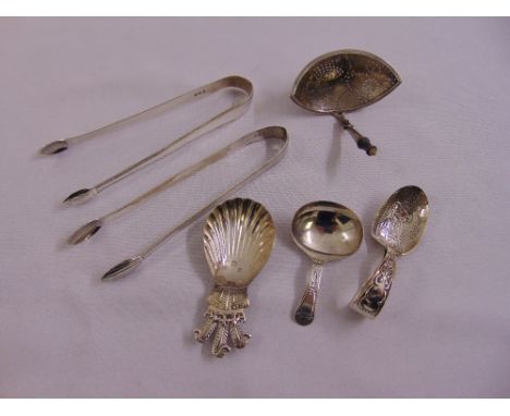 Two pairs of George III silver sugar tongs, marks for Thomas Wallis 1791 & 1793, a George III caddy spoon with Prince of Wale