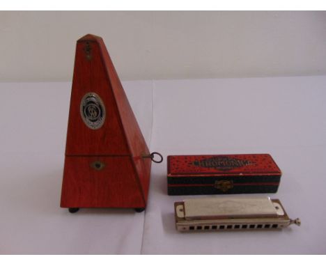 Hohner Super Chromonica harmonica in fitted packaging and a metronome