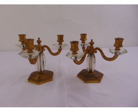 A pair of three light gilt metal and glass table candelabra on hexagonal bases