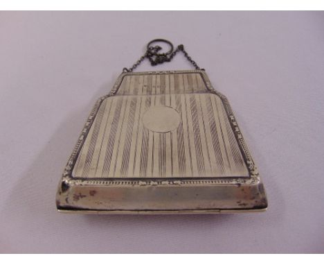 A silver hallmarked engine turned evening purse with hinged sides