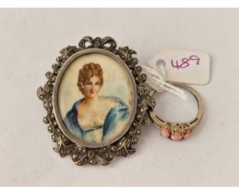 A silver three coral ring and paste porcelain brooch