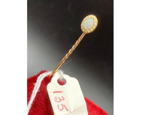 A pretty antique fiery opal and seed pearl stick pin in high carat gold