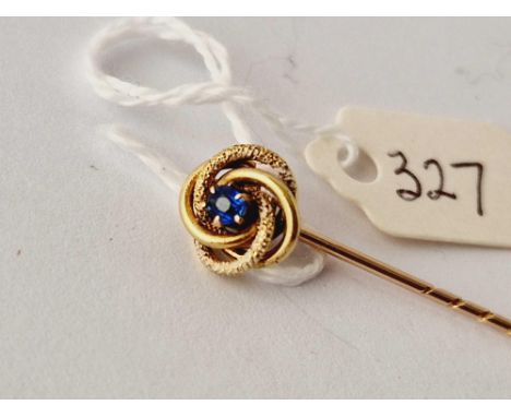 A gold stick pin with sapphire