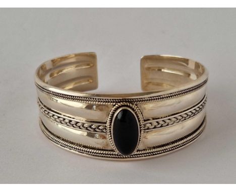 A large silver bangle set with black stone 39 gms