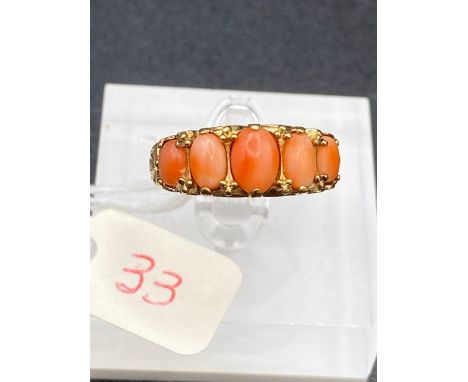 A fine antique coral five stone ring 9ct in period gold mount.