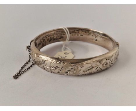 A silver chased topped bangle 1971