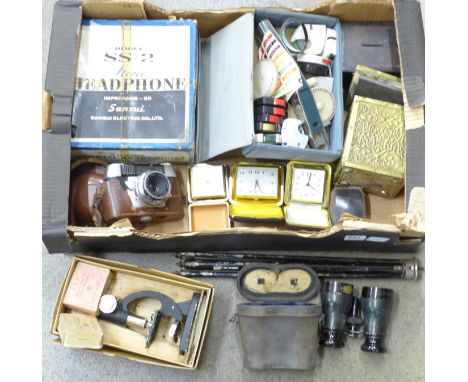 A student's microscope, boxed, a pair of opera glasses, cased, Prinz Mastermatic camera and tripod, three travel clocks, a te