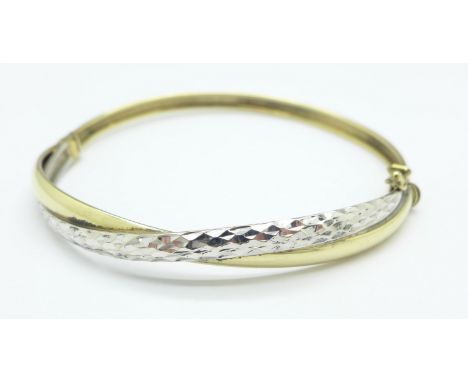 A 9ct two colour gold bangle, 5.9g
