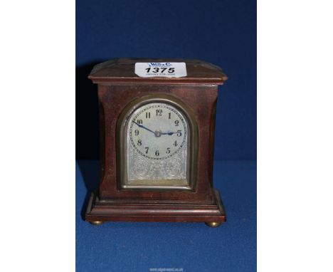 A small mantle clock with Arabic numerals, 5'' tall.
