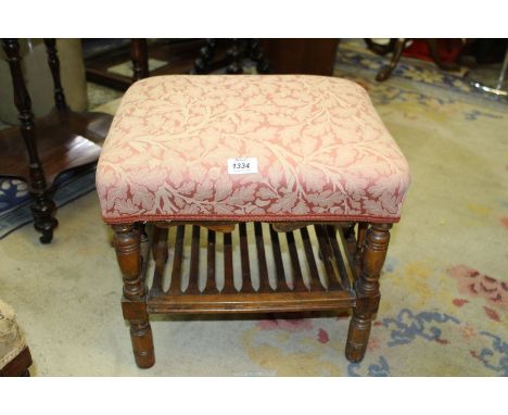 A rectangular Stool standing on turned legs united by a slatted lower shelf, 17'' x 13 1/2'' x 16'' high, the seat upholstere