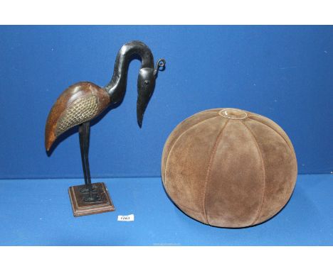 A metal and wooden Bird ornament and a vintage suede Medicine ball.
