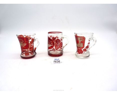 Three antique Bohemian ruby red etched cups including; one depicting two birds in a woodland scene, one with pontil mark, etc