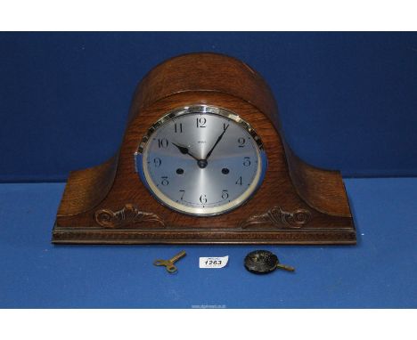 An Enfield wooden cased chiming mantle clock made for Dubros Stores with key and pendulum.