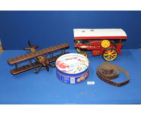 A model of a steam engine, wooden Bi-plane, leather strap and a small quantity of stamps.