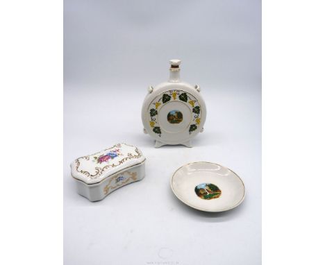 Three pieces of Hollohaza china including souvenir decanter and plate and a lidded box with floral and scroll decoration.