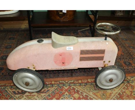 A child's tin plate toy car.