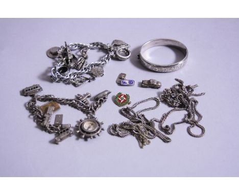 A HOLLOW SILVER EXPANDABLE BANGLE, with scroll decoration, together with white metal chains, charms, etc