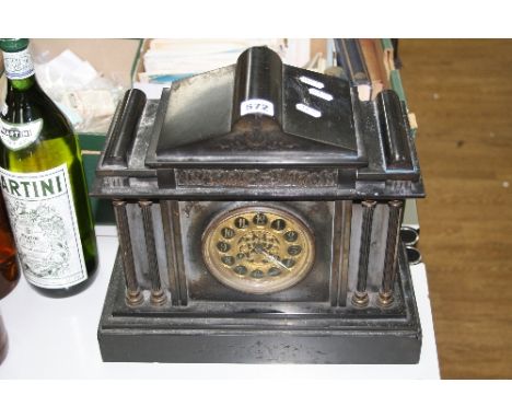 A BLACK MARBLE MANTLE CLOCK, of architectural form having ormolu dial with Arabic numerals, approximately 36cm x 16cm x 31.5c
