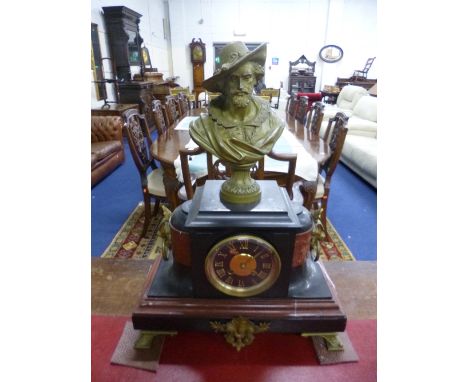 A BLACK SLATE AND RED MARBLE MANTEL CLOCK, with gilt figural mount, modelled as a bearded cavalier in hat over drum movement,