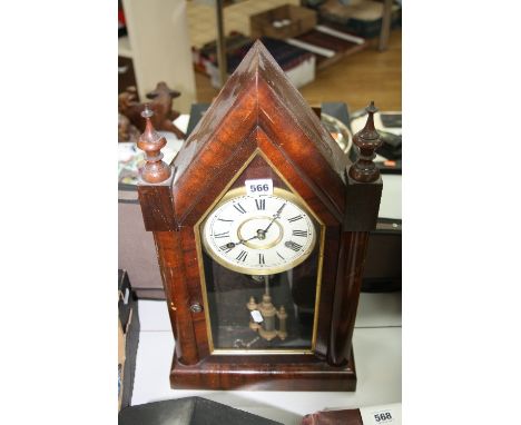 A MAHOGANY MANTLE CLOCK, of gothic form having twin urn finials, Roman numerals chapter ring to enamelled dial, approximately