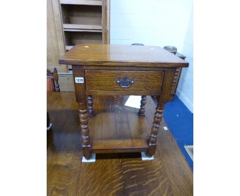 A SMALL OAK OCCASIONAL TABLE, with single drawer on bobbin turned supports and under shelf