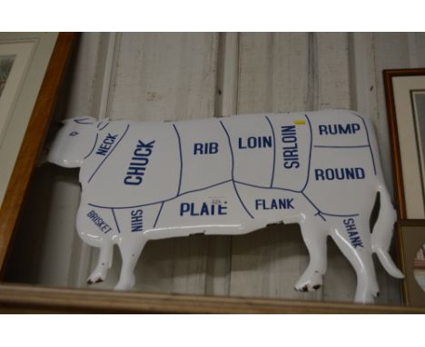 An enamel cow sign