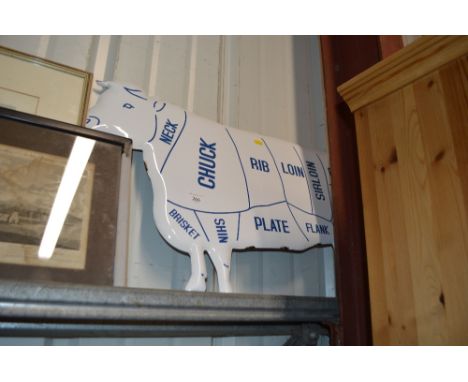 An enamel cow sign