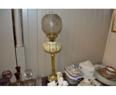 A late Victorian brass oil lamp with etched glass shade
