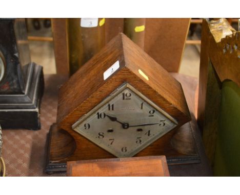 A 20th Century oak two hole mantel clock by D'arcy of Peterborough
