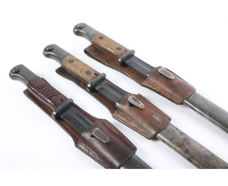 Three WWII German M1884/98 III-pattern bayonets for Mauser 8mm K98, each with steel scabbard and leather frog; one example wi