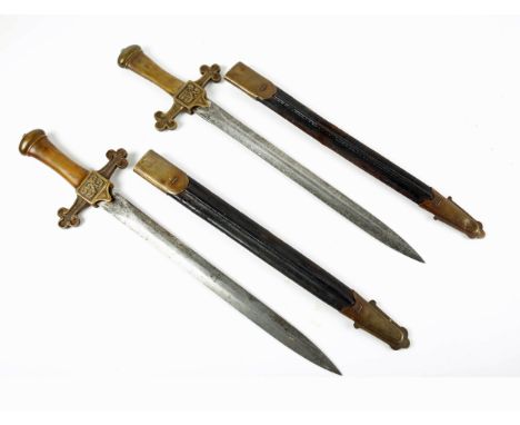 Victorian bandsman's dirks. A pair of short swords, the double edged blade on cast brass hilt with VR cypher, the cross guard