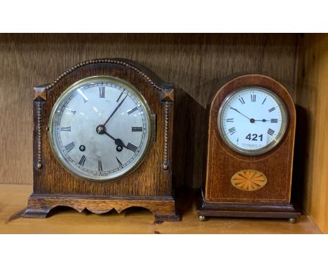 An Edwardian mahogany inlaid mantel clock, H. 20cm, together with a 1930's oak mantel clock.