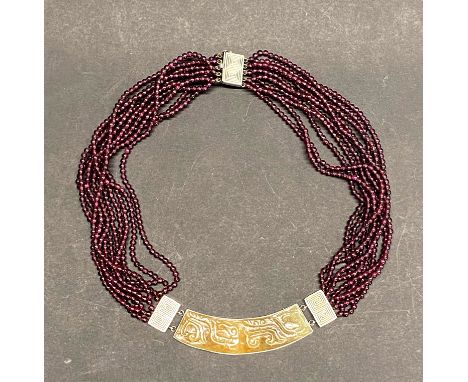 A beautiful Chinese carved russet jade, 925 silver and garnet necklace.