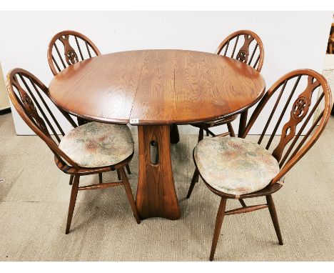 An Ercol oak drop leaf table with four matching Ercol chairs, table W. 106cm, extending to L. 120cm.