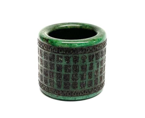 A Chinese engraved and inked jade/hardstone archers ring, W. 3cm, dia. 3.3cm.