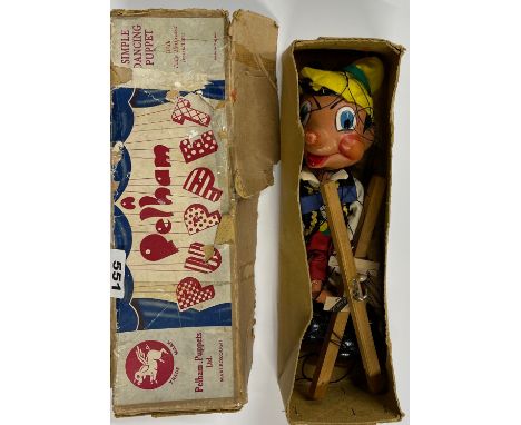 A boxed wooden Pelham puppet of Pinnocchio.