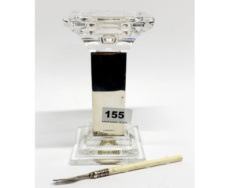 A hallmarked silver and crystal candlestick (circa 1980) with a hallmarked silver pickle fork (circa 1897).